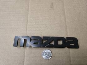 F00151 Mazda Oem Black Plastic 6.25 Inch Emblem Badge Logo Nameplate Name Plate 771