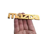 Mazda Trunk Emblem Badge Decal Logo Gold Rear 3 626 Protege Oem Genuine Used. Fixed Price $24.95.