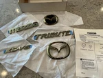 Genuine Mazda Tribute Gold Tone Emblems 2001-2006 ES-V6 0000-8R-G03 New. Fixed Price $79.95.