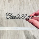 1977 1979 Cadillac Deville Fleetwood Header Grille Script Emblem # 1607891. Fixed Price $19.99.