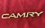 Genuine Toyota Camry Rear Emblem 75442-AA010 Gold 1997-2001. Fixed Price $17.00.