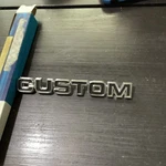 Nos 1975 Ford Van Custom Emblem D5UZ-16720-A. Fixed Price $35.00.