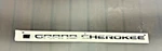 Genuine Mopar Grand Cherokee Nameplate Right With Flag Black 68571722AA. Fixed Price $70.00.