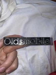 Oldsmobile Grille Emblem Metal Nameplate Ornament Script Trim 22524390. Fixed Price $30.00.