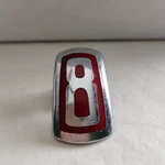 1946 Ford "8" Deluxe Hood Ornament Emblem Cylinder. Fixed Price $37.00.