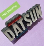 BIN20 Used 72 1973 1974 1975 1976 1977 Datsun Bluebird Grill Emblem 62810-U2001. Fixed Price $59.99.