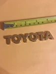 Gold Toyota Rear Trunk Emblem Badge Nameplate Ornament Genuine Used. Fixed Price $13.99.