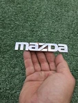 2002-2003 Mazda Protege Rear Emblem Ornament Badge Logo B25R-51-710 Oem. Fixed Price $5.00.
