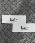 Aston Martin V12 Metal Badge Emblem Set AD23-43548-DA. Fixed Price $130.00.