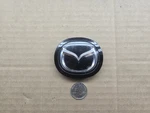Mazda Oem Black 2 7/8" Steering Wheel Horn Pad Emblem Badge Logo Name AAA171077. Fixed Price $19.99.