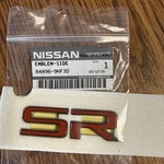Genuine Nissan "sr" Nameplate P/n: 84896-9HF3D. Fixed Price $22.99.