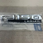 Ford Lariat Name Plate FL3Z-16720-E New In Package Oem. Fixed Price $19.99.