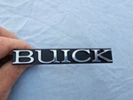New Old Stock 1978 Buick Century Radiator Grille Script 1256680. Fixed Price $26.99.