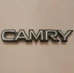 1987-1991 Toyota "camry" White Trunk Emblem P/n 75442 03010 With Pins. Fixed Price $6.99.