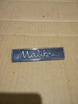 Chevy Malibu Circa '60S-'70S Door Panel Script Emblem 7727078 (3018) A8. Fixed Price $20.00.