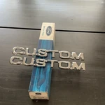 Nos 1980-1986 Ford Truck Custom Emblems Two E0TZ-16720-CA. Fixed Price $65.00.