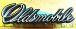 Circa 1970 Oldsmobile Script + Gasket Emblem 408950 / 409683 CE1343. Fixed Price $16.00.