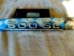 Mercedes 500 Sl Rear Emblem. Original Part. Brand New. Fits W107 Body. Fixed Price $120.00.
