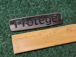 Mazda Oem 2001 2002 2003 Protege Sedan Rear Emblem Badge Logo Name 51 720 1M1. Fixed Price $13.99.