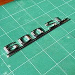 Mercedes Lettering R129 First Emblem Tailgate Aluminium 1298170515. Fixed Price $348.52.