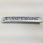 Mazda Oem 1993 1994 1995 Protege Rear Trunk Emblem Badge Logo Namep BR72 51 721. Fixed Price $13.99.