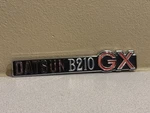 1974-1979 Datsun 210 Gx Emblem Nos 76895-H7700. Fixed Price $75.00.