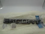 1987 1990 Nos Ford Escort Trunk Emblem Name Plate E7FZ-6142528-A New Oem. Fixed Price $24.95.