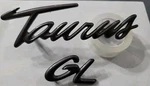Ford F6DB-17E939ABW "taurus Gl" Plastic Gunmetal Rear Emblem Oem Used. Fixed Price $10.00.