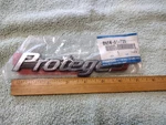 Nos New Damaged 2002-03 Mazda "protege" Nameplate BN5W-51-720. Fixed Price $9.95.