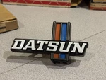 Nos 1977-1979 Nissan Datsun 620 J15 Front Grille Emblem 62394-B9500. Fixed Price $125.00.