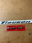 New 03-08 Hyundai Tiburon Gt V6 Rear Nameplate Emblem Oem 00229E3000/00282E5001. Fixed Price $50.28.