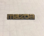 1995-1998 Mazda Protege Trunk Oem Emblem Logo Badge (8324K). Fixed Price $15.00.