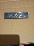 Chevy Malibu Circa '60S-'70S Door Panel Script Emblem 7727078 (3018) A50. Fixed Price $17.00.