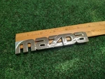 2002-2003 Mazda Protege Rear Emblem Ornament Maker B25R-51-710 Oem 3S8. Fixed Price $15.79.