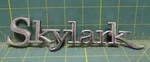Buick Skylark Emblem Nameplate 7736039 16166 Md 7.25" Long. Fixed Price $20.00.