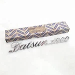 Datsun Sunny 1200 B110 Emblem Badge Rear Trunk Lid Genuine Parts Nos. Fixed Price $145.00.
