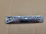 Mazda Oem 1993 1994 1995 Protege Rear Trunk Emblem Badge Logo Namep BR72 51 721. Fixed Price $13.99.