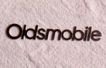 Vtg Oldsmobile Thin Metal Emblem Logo 5.5" Silver Color Nameplate Badge. Fixed Price $12.00.