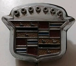Cadillac 1971-76 Trunk Emblem Lock Badge. Fixed Price $85.00.