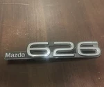 Oem Mazda 626 Rear Trunk Emblem Name Badge GJ21 51 720. Fixed Price $12.00.