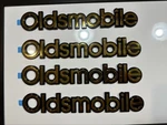 New Gold Plated Rear Emblem Name Oldsmobile Logo 10"X1.25" Stick On Badge. Fixed Price $17.99.