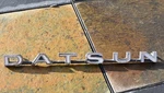 Oem Vtg 1970S Metal Nissan Datsun Emblem Script Badge S280025500. Fixed Price $88.00.