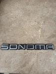 Genuine 1994-2004 Gmc Sonoma Door / Tailgate Nameplate Emblem. Fixed Price $19.99.