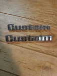 D6TB99201B62AA Ford Custom Emblem Set Of. Fixed Price $75.00.