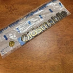 Nos Oem Oldsmobile Silhouette Apv Rear Panel Nameplate Emblem 1998 - Gold. Fixed Price $10.95.