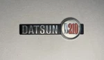 Datsun B210 Emblem Badge Nameplate Oem Used Plastic Original. Fixed Price $15.00.