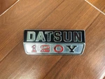 Datsun Sunny 120Y B210 1974-1977 Rear Panel Emblem Badge Genuine 79805-H5005. Fixed Price $79.99.