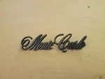 1970-72 Monte Carlo Rear Tail Panel Script Emblem 01904. Fixed Price $50.00.