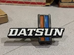 Nos 1977-1979 Nissan Datsun 620 J15 Front Grille Emblem 62394-B9500. Fixed Price $135.00.