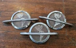 Lot Of 3 1954 Oldsmobile Hood Emblems Ornament Super 88 98 Globe Rocket. Fixed Price $189.00.